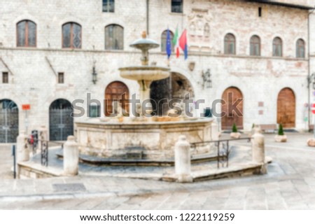 Defocused background with fountain of three lions in Assisi, Italy. Intentionally blurred post production for bokeh effect