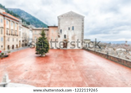 Defocused background of Piazza Grande, scenic main square in Gubbio, Italy. Intentionally blurred for bokeh effect