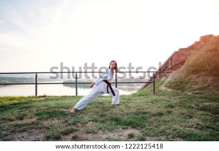 The karate girl with black belt.
