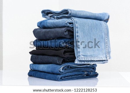 Blue and  black jeans trousers stack on white background for supermarket concept
 Royalty-Free Stock Photo #1222128253