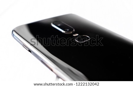 Closeup black modern smartphone on the white wooden table