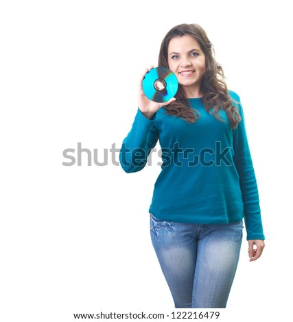 Attractive smiling young woman in a blue shirt holding a disk in her right arm. Isolated on white background