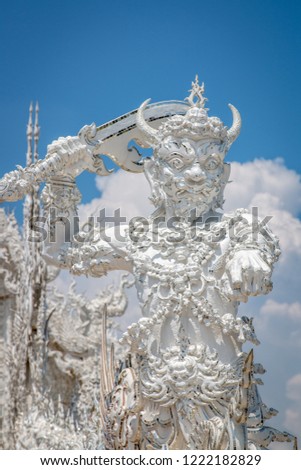 Giant security measure. White temple at Wat Rong Khun Chiang Rai Thailand.