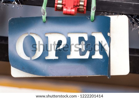 Damaged sign with text Open hang on door of shop. Aged board Open of coffee shop.