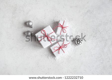 Christmas Gift Boxes in white background, copy space. White Christmas Gifts and silver balls, winter festive composition, mockup, concept.