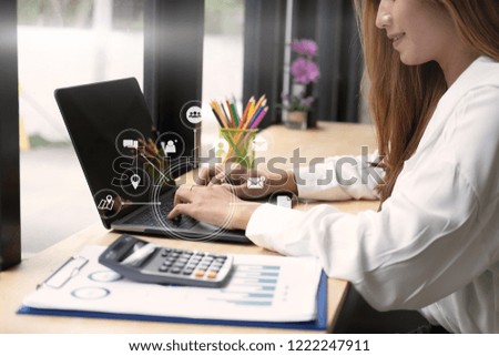 Business woman working with computer analysis data of finance and visual icon technology.