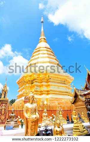 Beautiful buddha image and golden pagoda with blue clear sky and white clouds,  Phra That Doi Suthep  Temple ,the famous place for thai people and buddhist in chiangmai Thailand