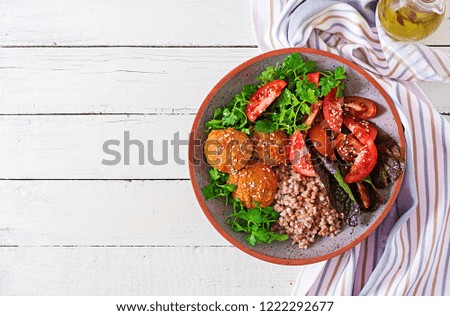 Meatballs, salad of tomatoes and buckwheat porridge on white wooden table. Healthy food. Diet meal. Buddha bowl. Top view. Flat lay