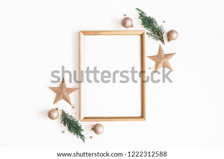Christmas composition. Photo frame, golden decorations, fir tree branches on white background. Christmas, winter, new year concept. Flat lay, top view, copy space