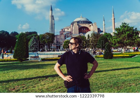 Journey. The guy stands on the background of the mosque in Istanbul