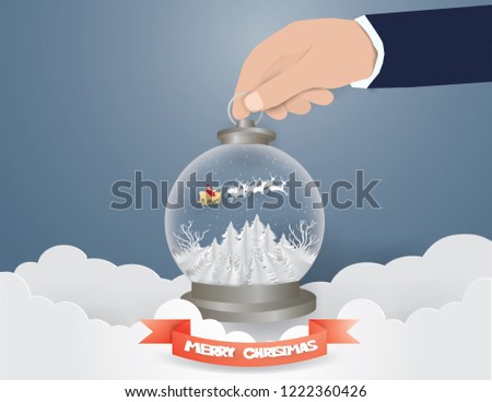 Merry Christmas concept,Hand  Picked Santa Claus and sled and deer on the sky in Snow globe,Paper art and Illustration style.