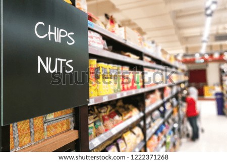 Chips and Nuts signage grocery categoy aisle at supermarket