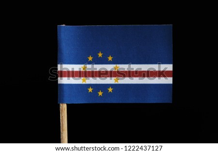 A national flag of Cape Verde on toothpick on black background. Consists from five unequal horizontal bands of blue, white, red, white and blue with circle of yellow stars.