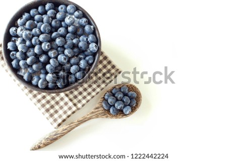 Fresh Blueberry in wooden cup on white table background