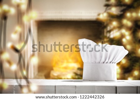White cook hat on white wooden table and christmas decoration. Free space for your decoration. 