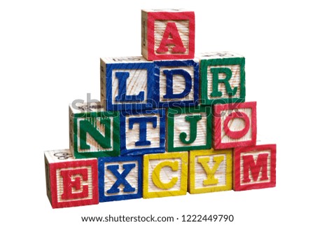 Wooden alphabet building block isolated on white background.
