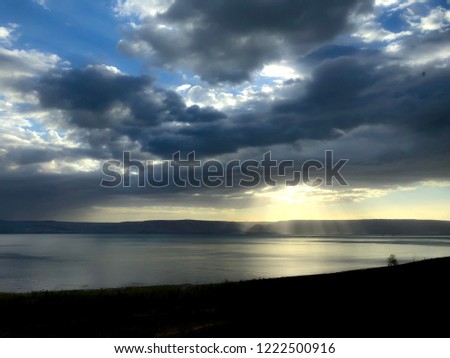 Sunlight breaking through the clouds on The Sea of Galilee in Israel.