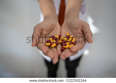 Hand of doctors holding many  pills
