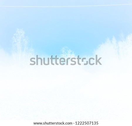 White silhouettes on blue sky background filtered photo, winter abstraction