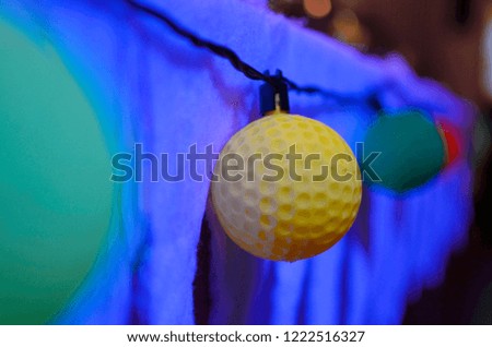 Christmas decorations, New Year's Eve with a garland of multi-colored balls that glows with a multi-colored light.