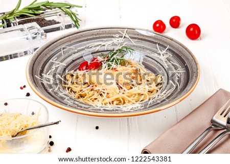 Carbonara pasta with chicken, parmesan and egg on white background. Delicious close up view. Picture for recipes or books. Close up 45 degree view. Copy space for text, logo or brand