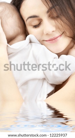 picture of happy mother with baby boy in water