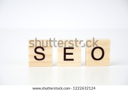 SEO, Search Engine Optimization word collected of wooden elements with the letters and also magnifying glass.