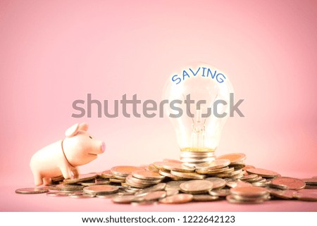 Creative ideas of saving money concept with lightbulb and piggy bank on coins pile.  Business planning for the future