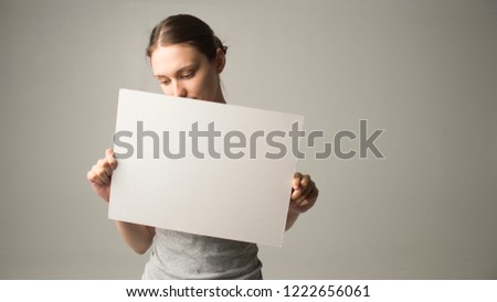 woman holding a sheet of paper in her hand