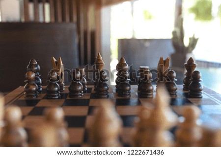 Closeup image of a wooden chess set on chessboard