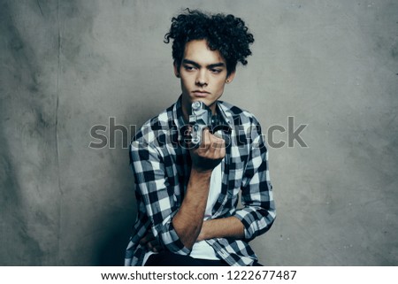 a guy with a curly head with a camera in his hands                     