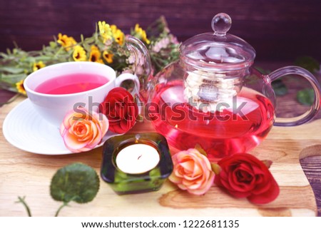 rose tea and flower in the glass pot with candle and flower with purple color effect