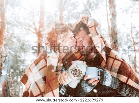 winter holiday concept. couple in love is having fun under the snow. 