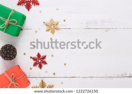 Top view of snowflakes,Christmas gift  ,Pine cones on  wooden white background and copy space.