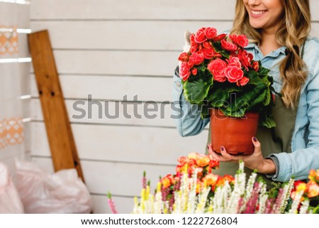 Florist holding pot of flower