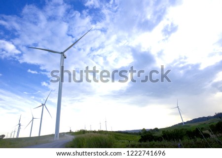 windmills with blue sky and beautiful mountain , cloud and sunset light background, An idea of energy product or save energy on dailylife. Khao Kho District, Phetchabun province Northern Thailand.