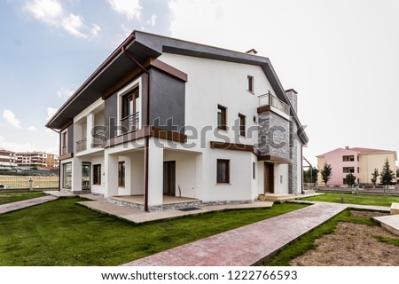 Newly built two storey house on an apartment site Royalty-Free Stock Photo #1222766593