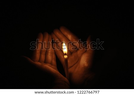 The hand that protects the candles in the dark.