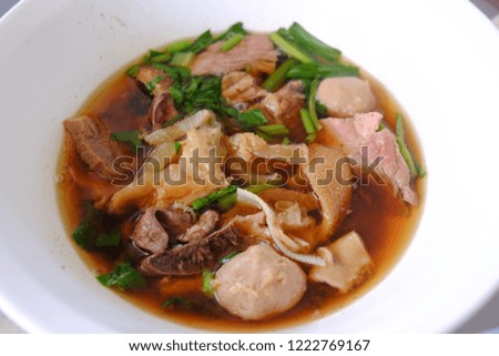 Thai beef soup in white bowl. Selective focus