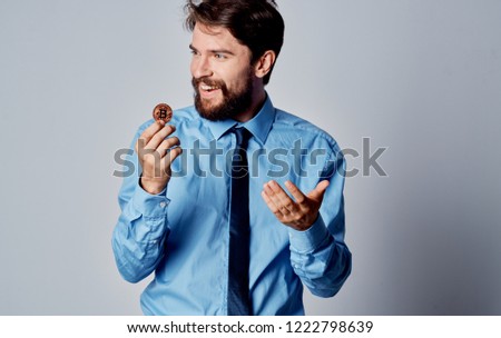 man in shirt and tie holding Bitcoin cryptocurrency                         