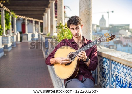 Fado musician playing on portuguese guitar in Lisbon, Portugal 