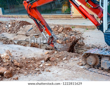 excavation with a narrow section to bury corrugated plastic cable ducts for the production of a fiber optic telecommunication cable distribution network.