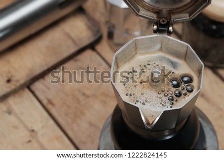 Preparing fresh coffee in moka pot on stove / Espresso in Moka pot old coffee maker.