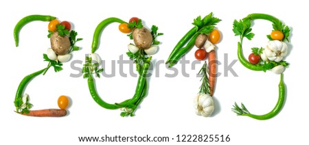 Number 2019 written with vegetables, as a metaphor or concept for healthy food, living, diet, recipe. Isolated on white background. Happy new year. End of the year resolution  Royalty-Free Stock Photo #1222825516