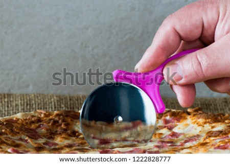 Cutting some pizza slices