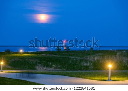 Milwaukee Breakwater Lighthouse and full moon. Milwaukee, Wisconsin, USA.