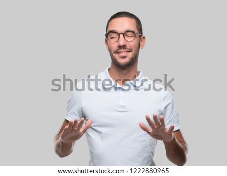 Happy young man with a gesture of keep calm