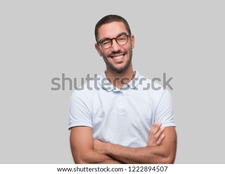 Happy young man winking an eye