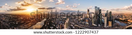 panorama high-rise buildings and transport of metropolis, traffic and blurry lights of cars on multi-lane highways and road junction at sunset in Moscow. Royalty-Free Stock Photo #1222907437