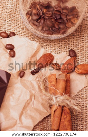 Homemade chocolate for cafes and bars. Cinnamon closeup against the background of a cup of tea. Tea with nuts and a bar of chocolate